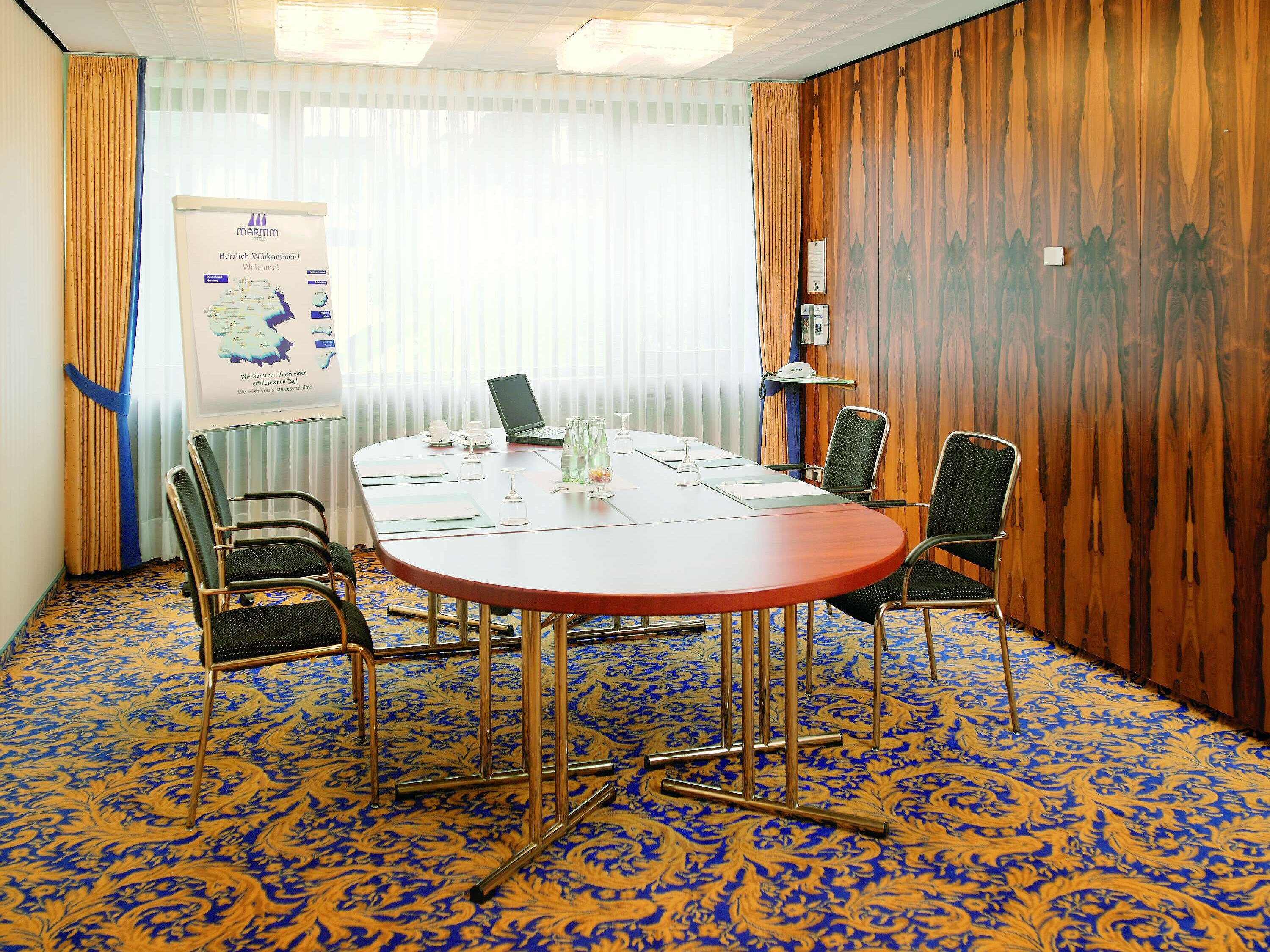 Bright meeting room with conference table at Maritim Hotel Bad Salzuflen for small meetings
