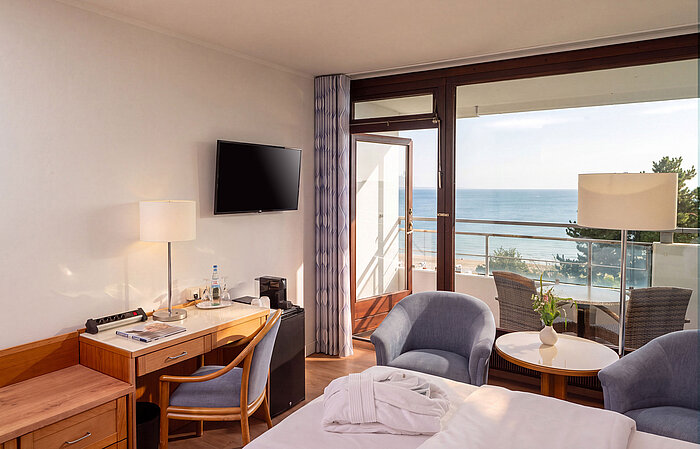 Superior room with desk, seating area and balcony overlooking the Baltic Sea
