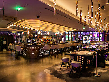 Stylish hotel bar with gaming tables and modern lighting at Maritim Hotel Plaza Tirana