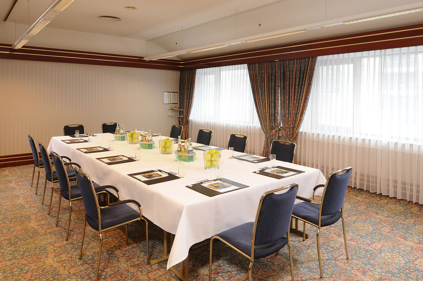 Bright meeting room with U-shaped seating and fresh decor at Maritim Hotel Magdeburg.
