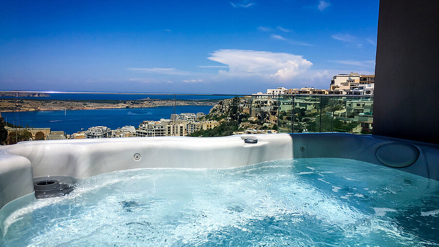 Outdoor hot tub with stunning views of the sea and coastline