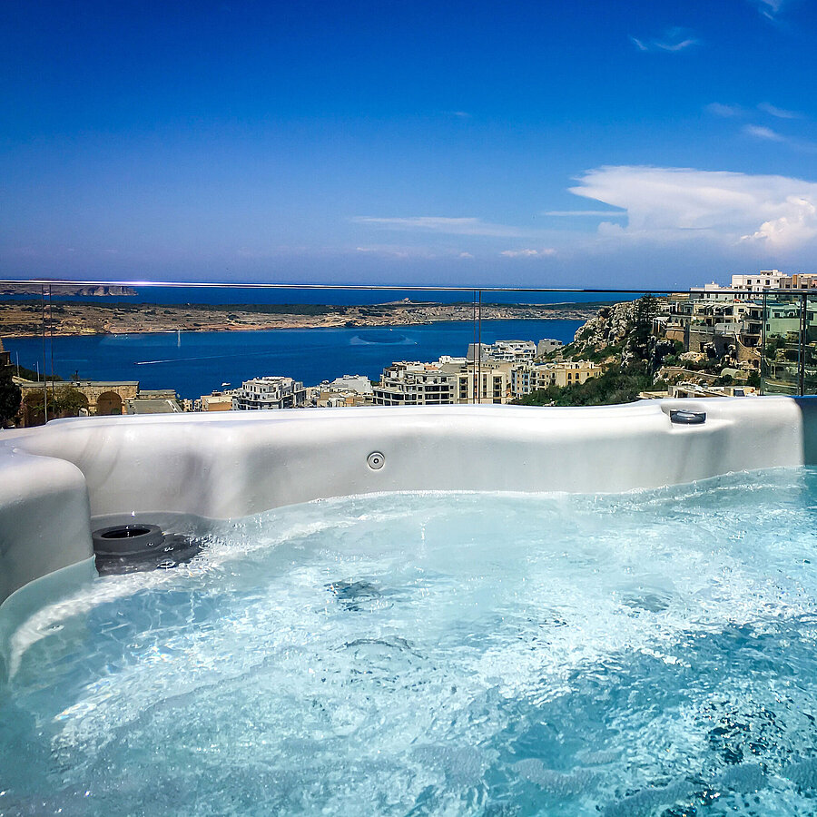 Outdoor hot tub with stunning views of the sea and coastline