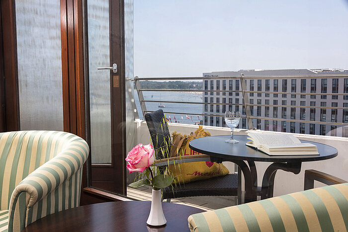 Cosy balcony with book, rose and water view at Maritim Hotel Travemünde