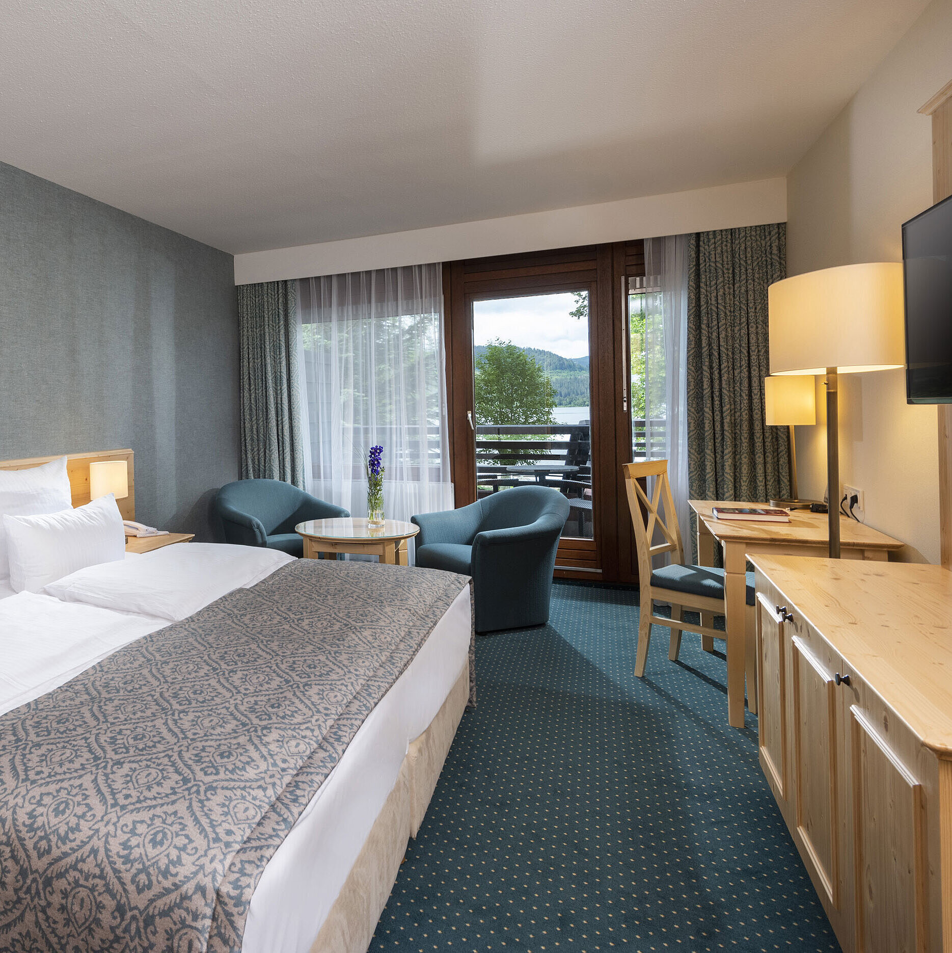Modern hotel room at Maritim Hotel Titisee with balcony and lake view