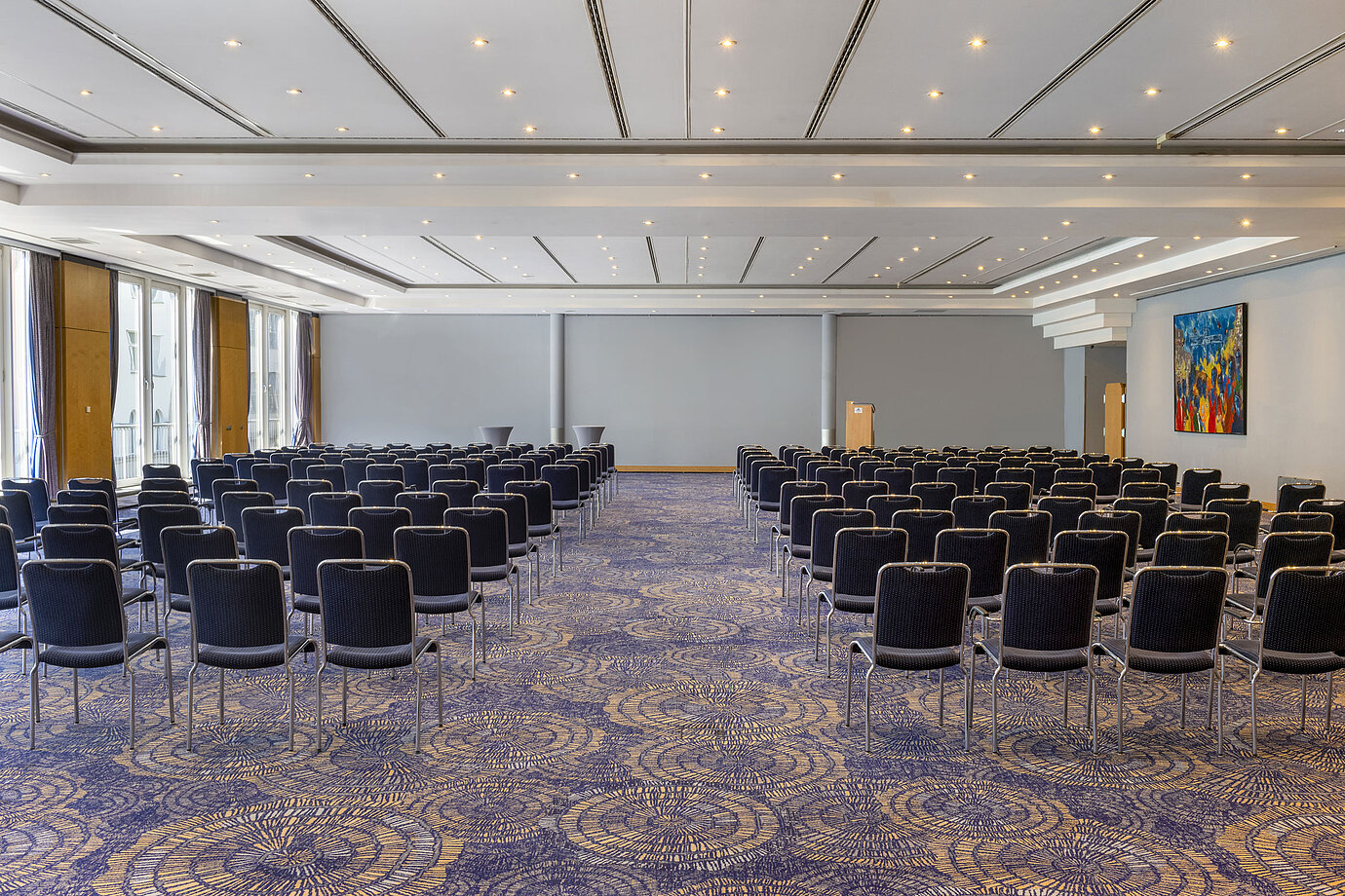 Large conference room Hall II at Maritim proArte Hotel Berlin with rows of chairs and bright ambiance, perfect for meetings.