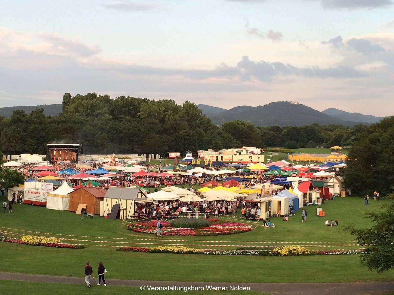 Large open-air festival with colourful tents, stages and visitors in Bonn’s Rhine meadows