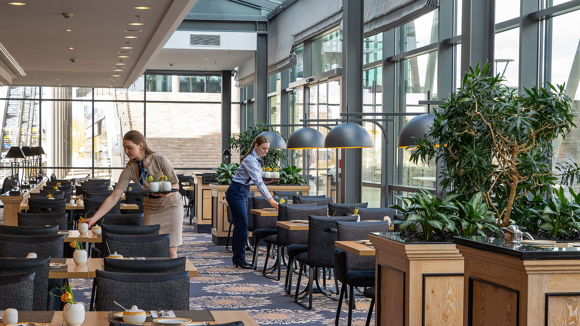 Wintergarten Restaurant Bright interior of Restaurant Wintergarten at Maritim Hotel Dresden with large windows and elegantly set tables.