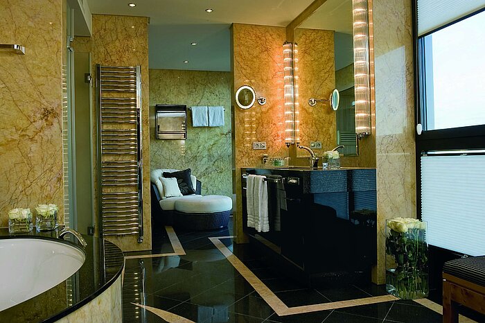"Luxurious bathroom of the Presidential Suite at Maritim Düsseldorf with marble walls, modern fittings, and elegant lighting