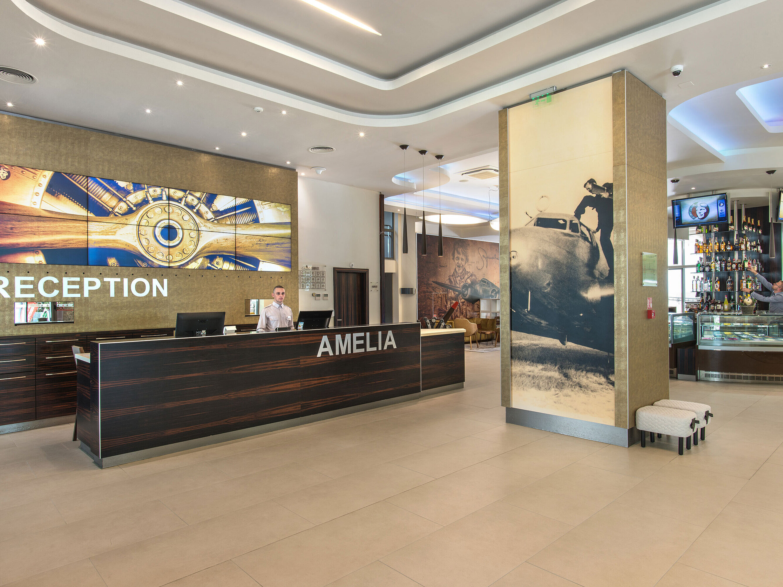 Reception of the Maritim Hotel Amelia with modern design, large wall display and stylish details in a bright welcoming lobby