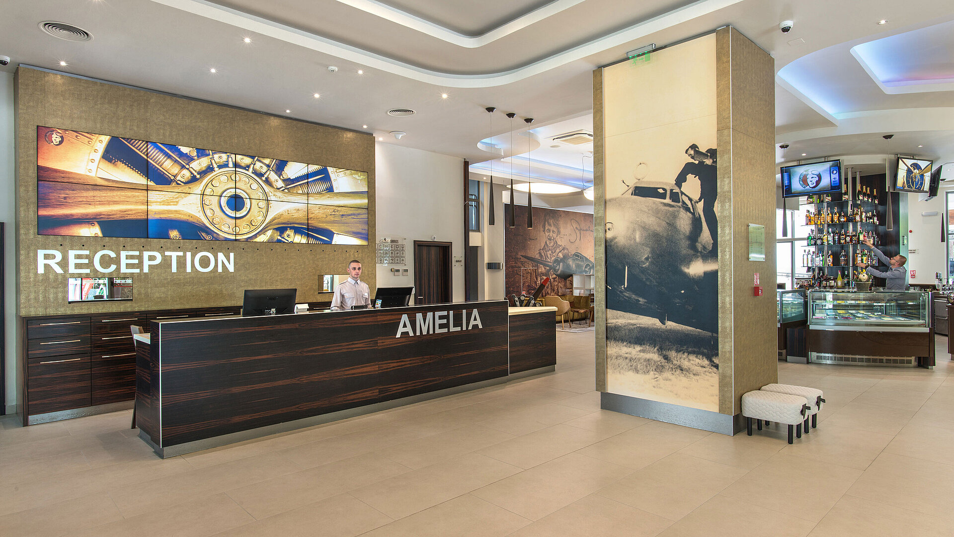 Reception of the Maritim Hotel Amelia with modern design, large wall display and stylish details in a bright welcoming lobby