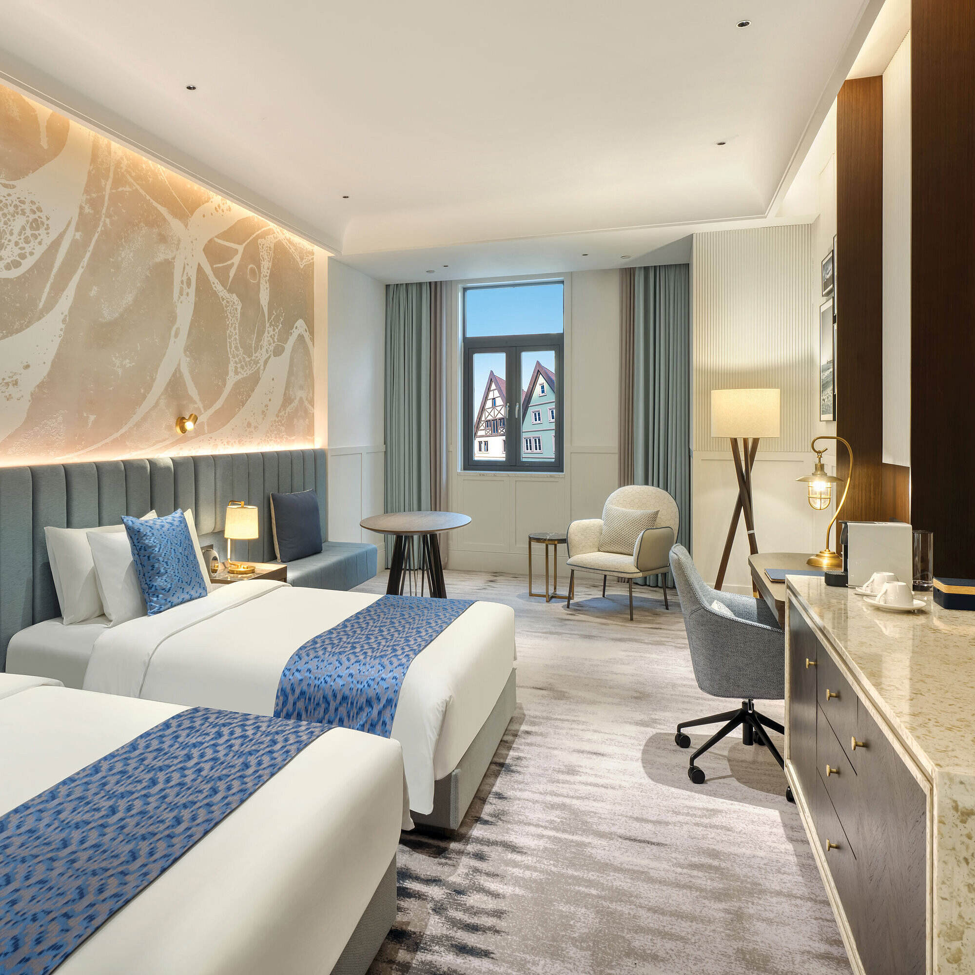 Modern twin room with elegant details, seating area and bright window view at Maritim Hotel Taicang