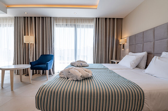 Bright double room with cosy seating area and floor-to-ceiling windows