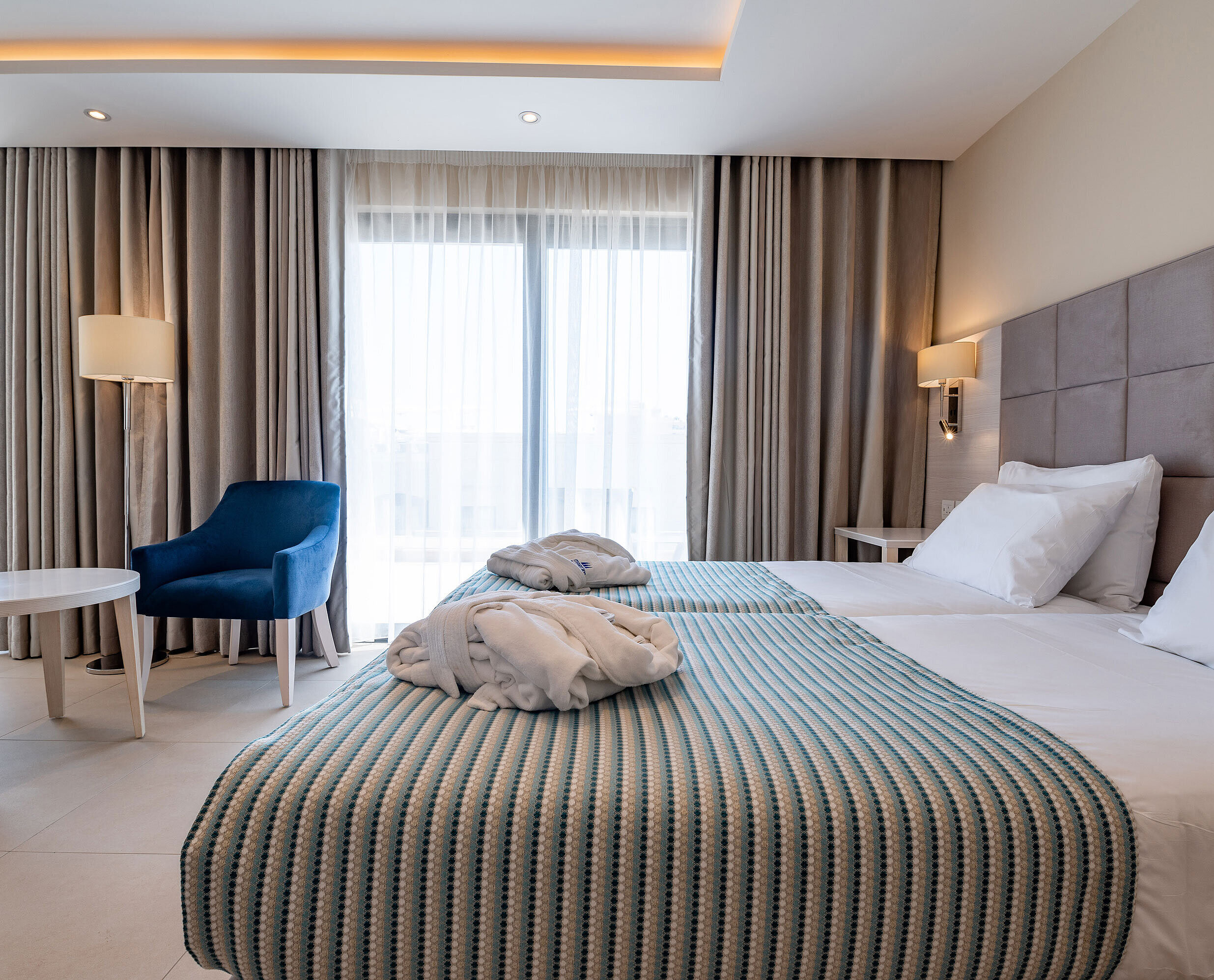 Bright double room with cosy seating area and floor-to-ceiling windows