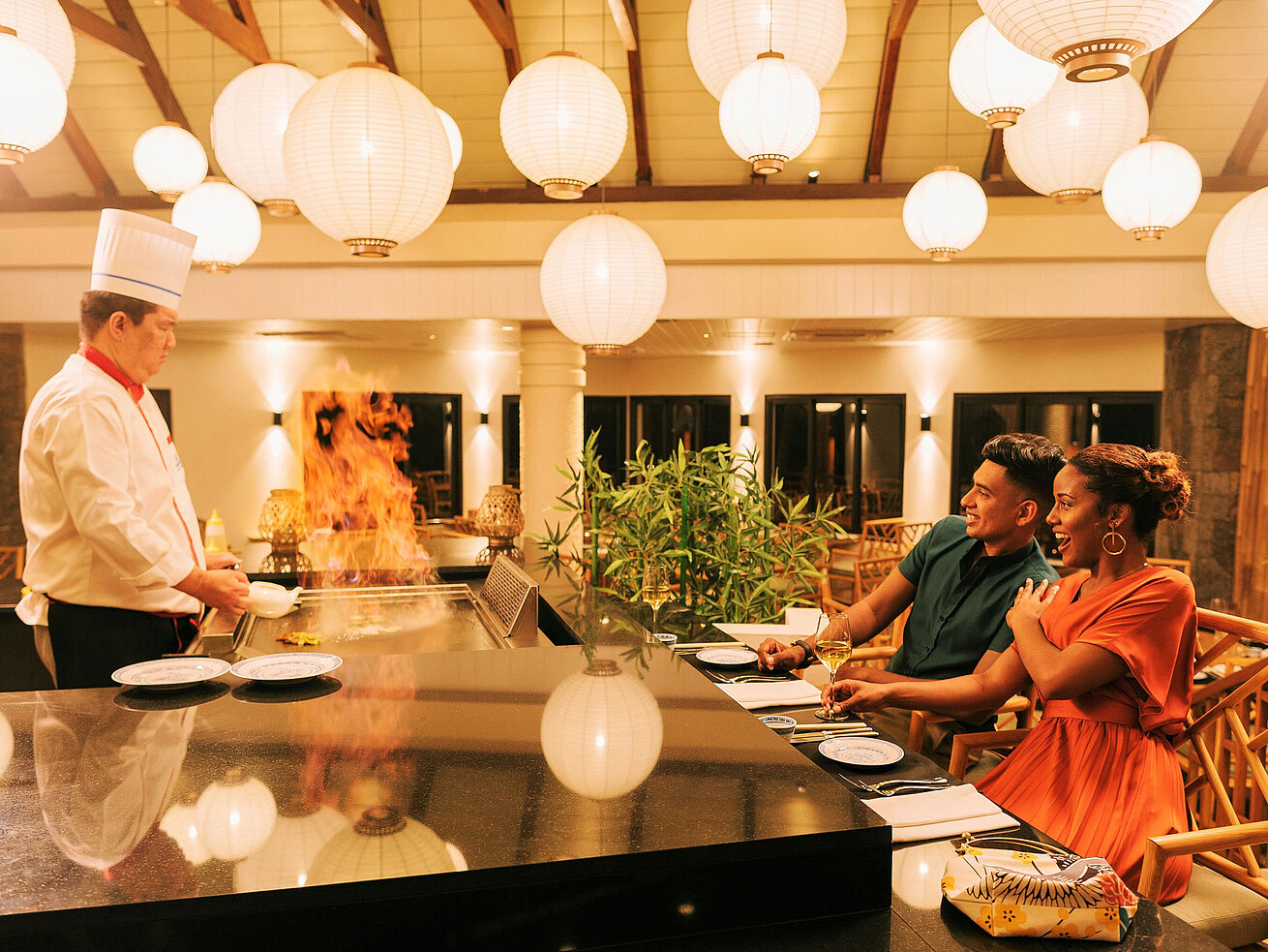 Guests enjoying live cooking at the grill with a show effect