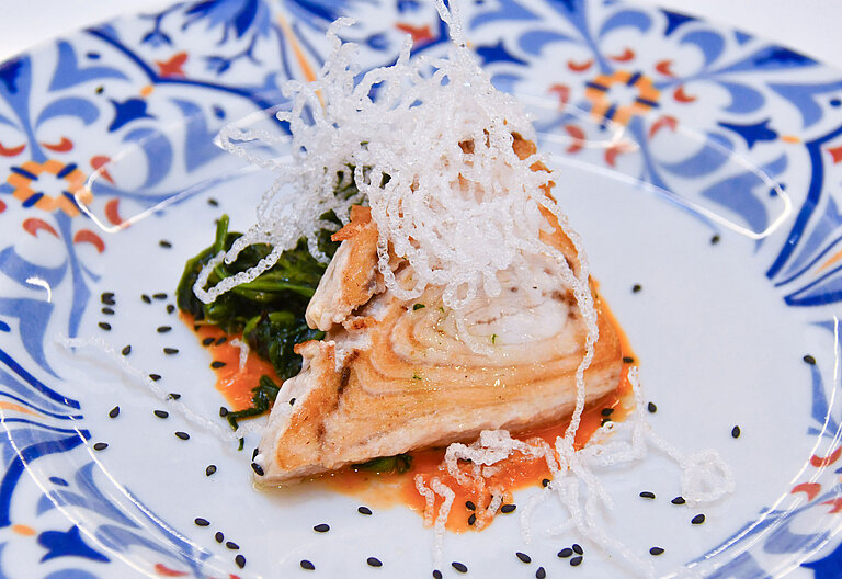Artfully plated fish fillet with vegetables on ceramic plate at Maritim Resort Calabria