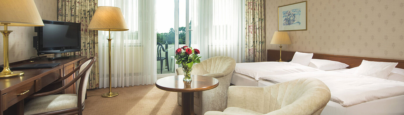 Bright double room with terrace access and sitting area at Maritim Hotel Bad Wildungen