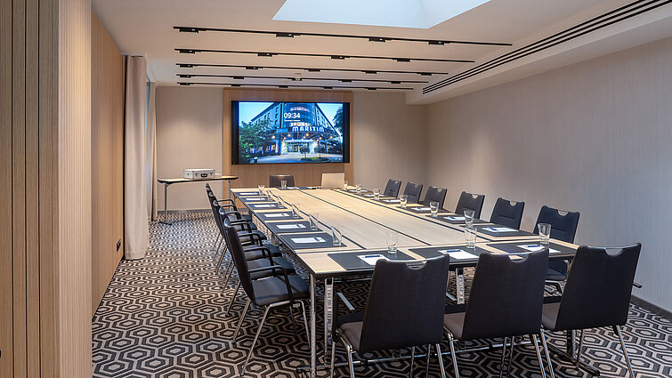 Meeting room 2 with large conference table, modern media technology and a clean, professional layout.