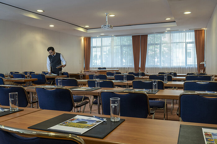 Bright meeting room at the Maritim Hotel Magdeburg with row seating, natural light, and modern equipment.