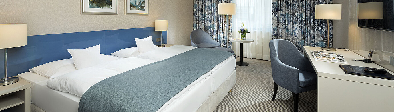 Superior room at Maritim Hotel Bonn with stylish design, cozy beds, modern desk, and comfortable seating area.