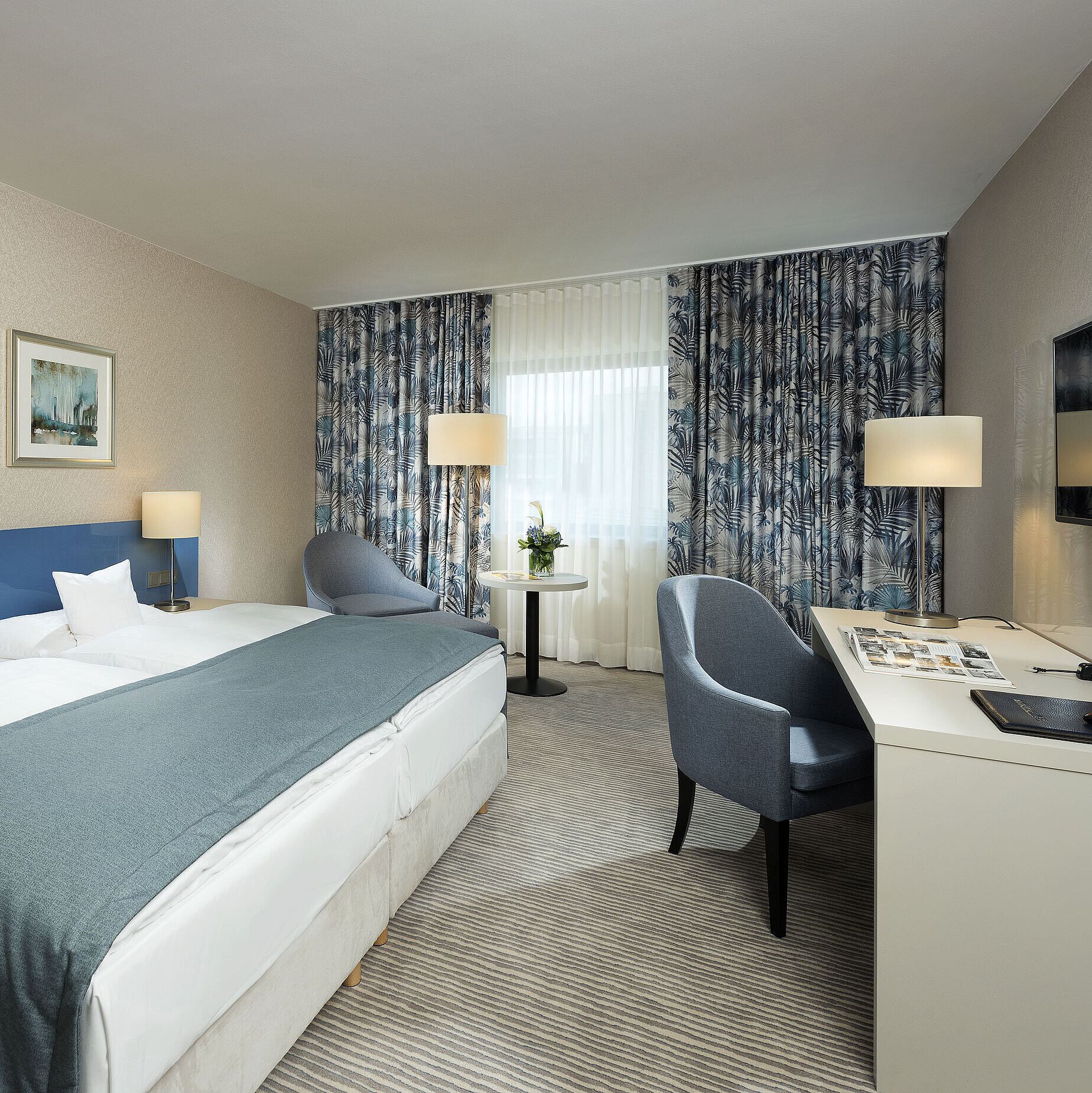 Superior room at Maritim Hotel Bonn with stylish design, cozy beds, modern desk, and comfortable seating area.