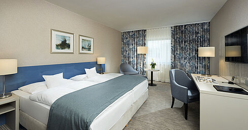 Superior room at Maritim Hotel Bonn with stylish design, cozy beds, modern desk, and comfortable seating area.