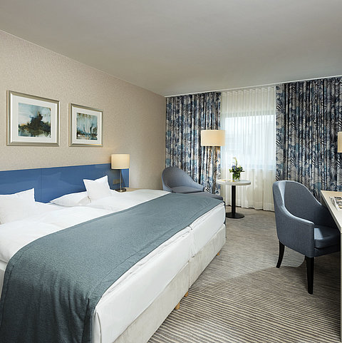 Superior room at Maritim Hotel Bonn with stylish design, cozy beds, modern desk, and comfortable seating area.