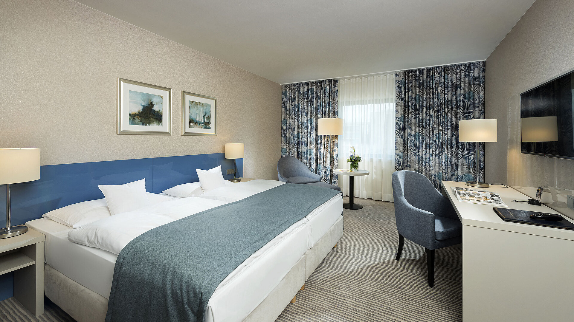 Superior room at Maritim Hotel Bonn with stylish design, cozy beds, modern desk, and comfortable seating area.