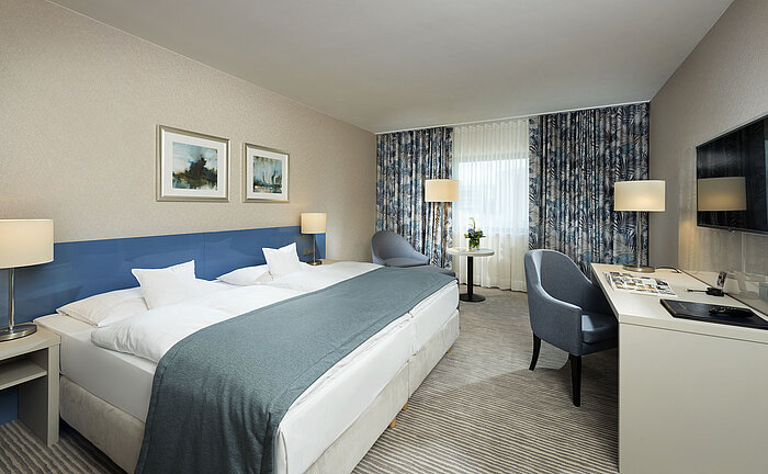 Superior room at Maritim Hotel Bonn with stylish design, cozy beds, modern desk, and comfortable seating area.