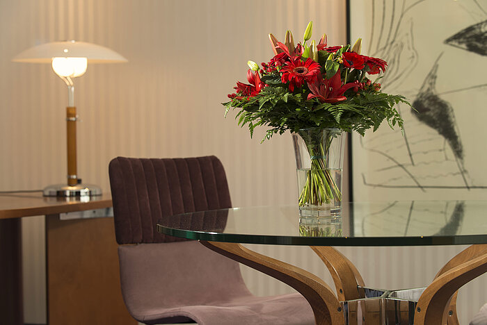 Elegant bouquet on a glass table in the Presidential Suite at Maritim proArte Hotel Berlin.