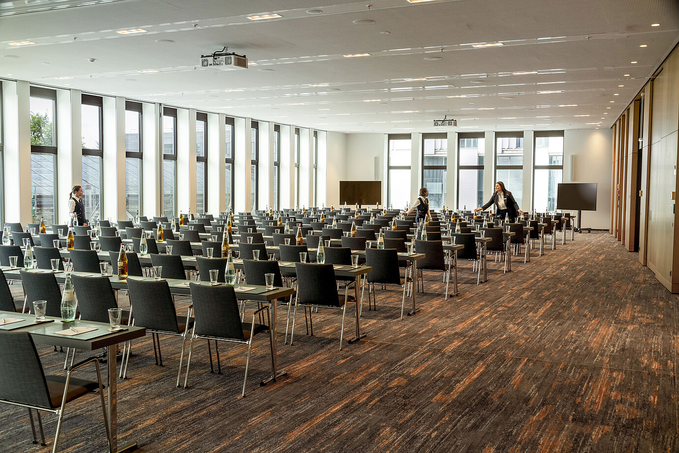 Conference room at Maritim Hotel Ingolstadt with row seating, modern technology, and bright windows.