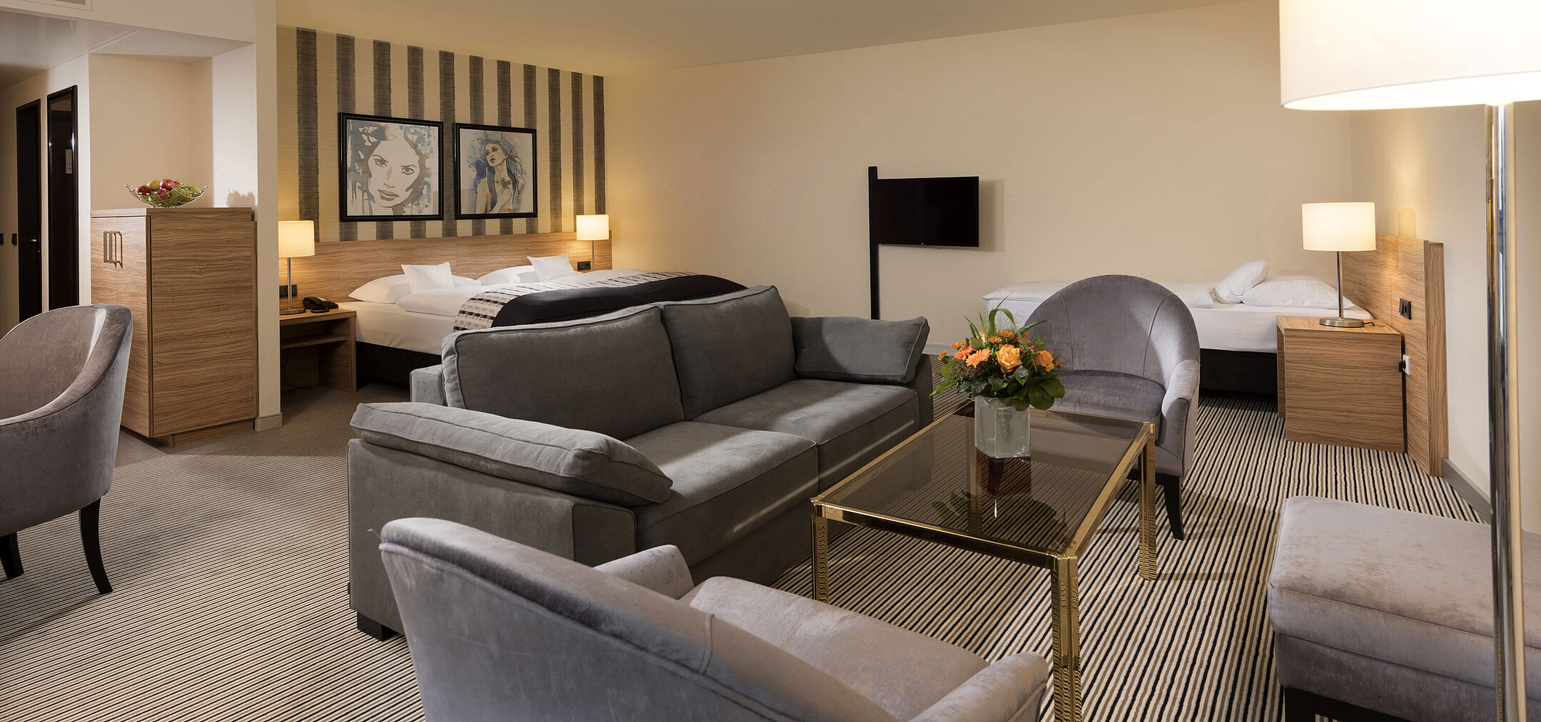 Spacious suite at Maritim Hotel Königswinter with cozy seating area and stylish design.