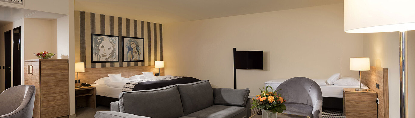 Family room Family room at Maritim Hotel Königswinter with seating area and stylish design.
