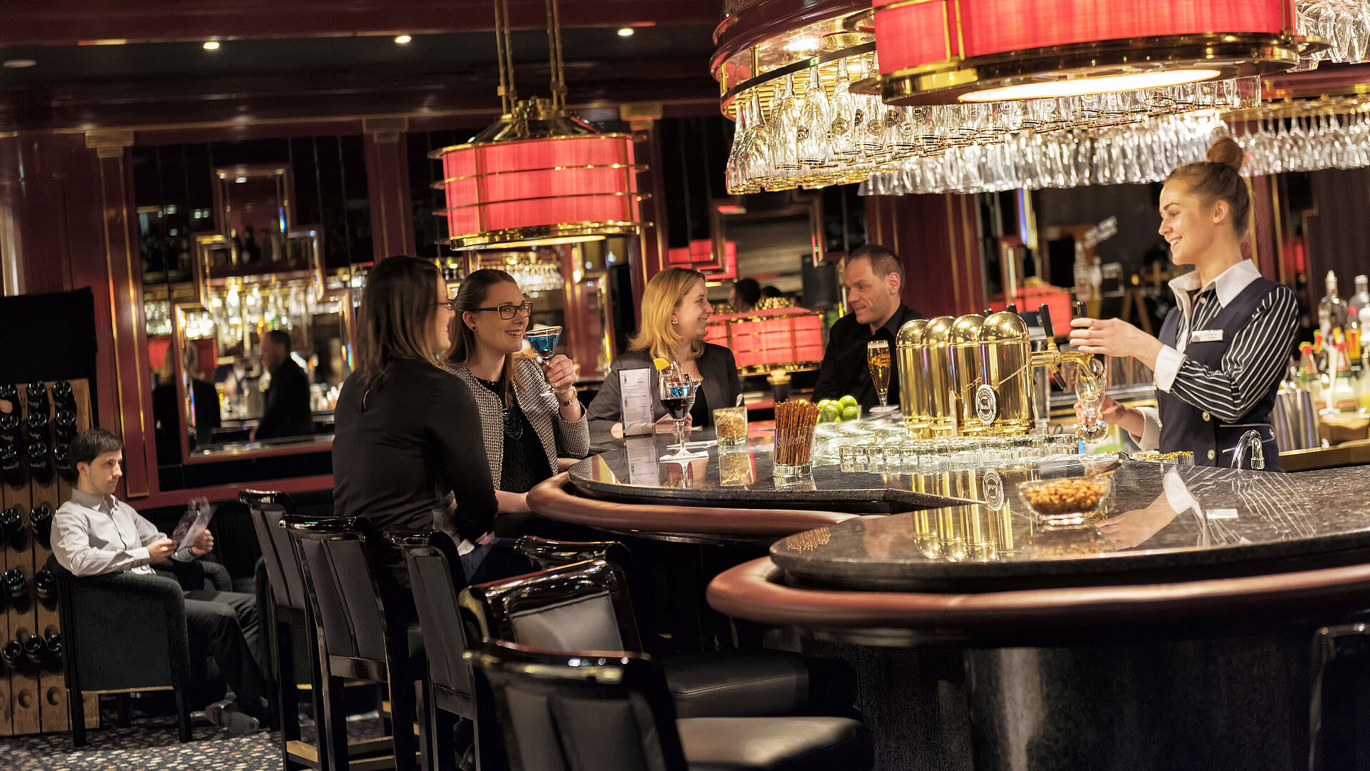 Guests enjoy cocktails and conversation in a stylish setting at the Maritim Hotel Ulm bar
