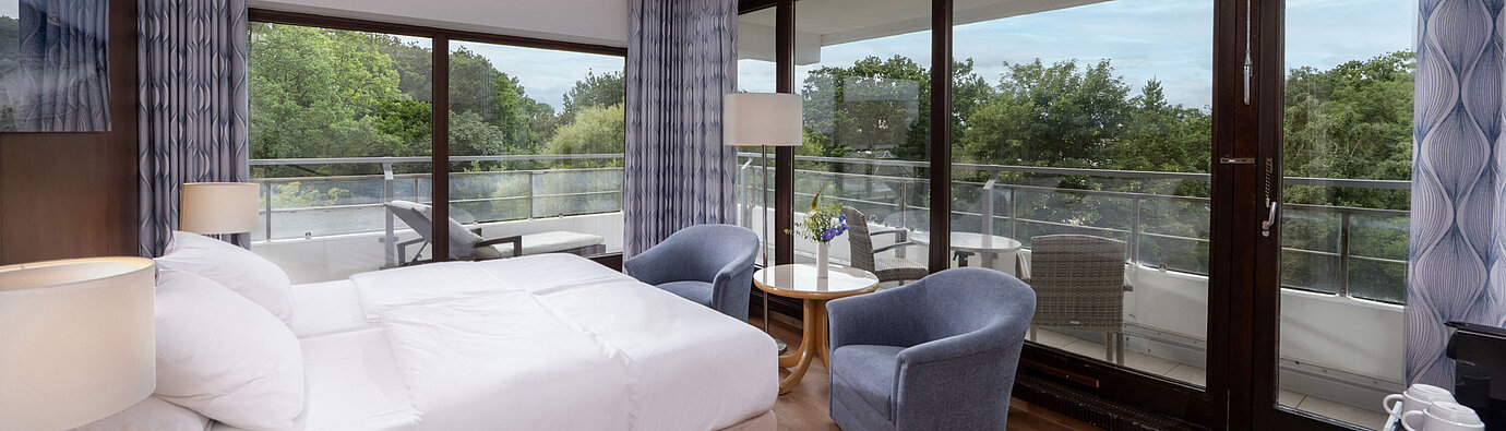 Bright room at Maritim Seehotel Timmendorfer Strand with large balcony and garden view