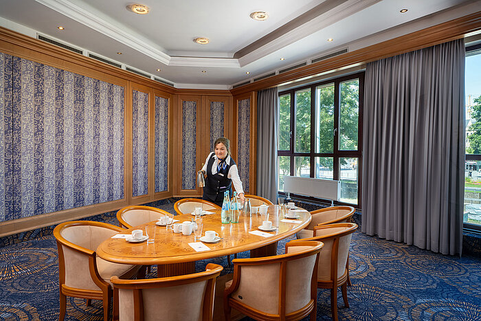 Small meeting room at Maritim Hotel Köln with service and set conference table