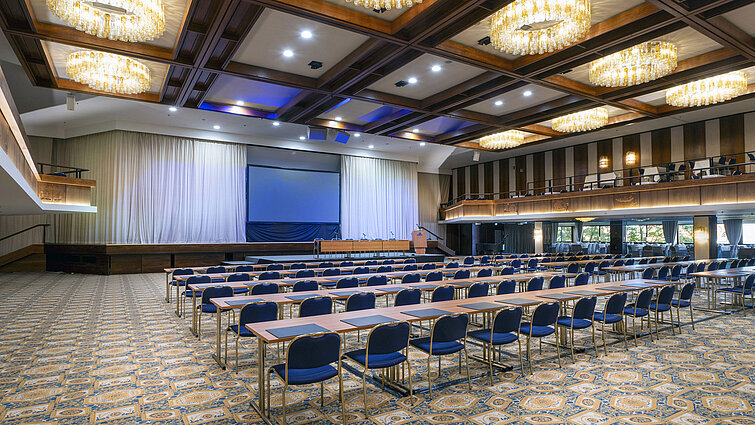 Spacious hall with stage, screen and row seating at Maritim Hotel Travemünde