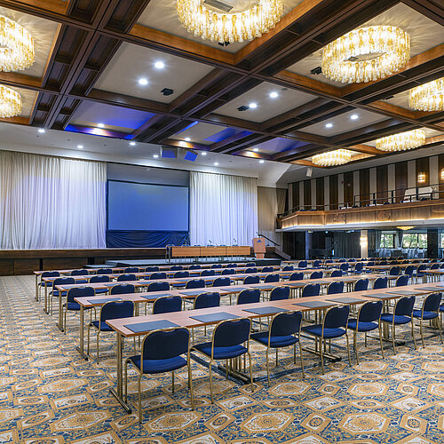 Spacious hall with stage, screen and row seating at Maritim Hotel Travemünde