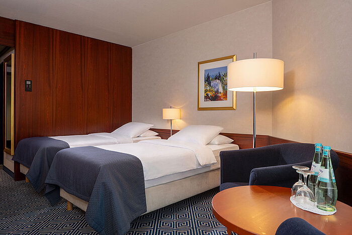 Classic Twin room Classic Twin room at Maritim Hotel Würzburg with two single beds, seating area and modern comfort