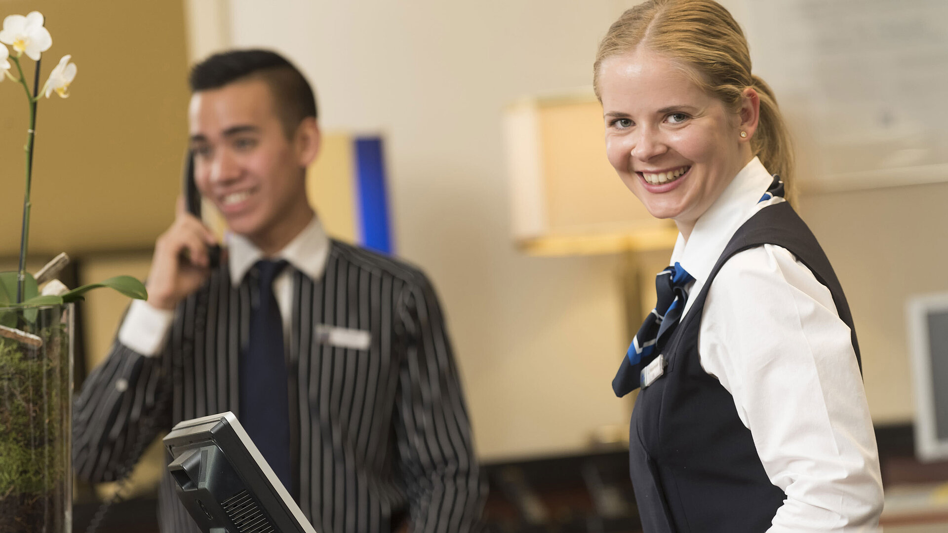 Smiling staff at the reception of Maritim Hotel Bad Homburg offer a warm welcome.