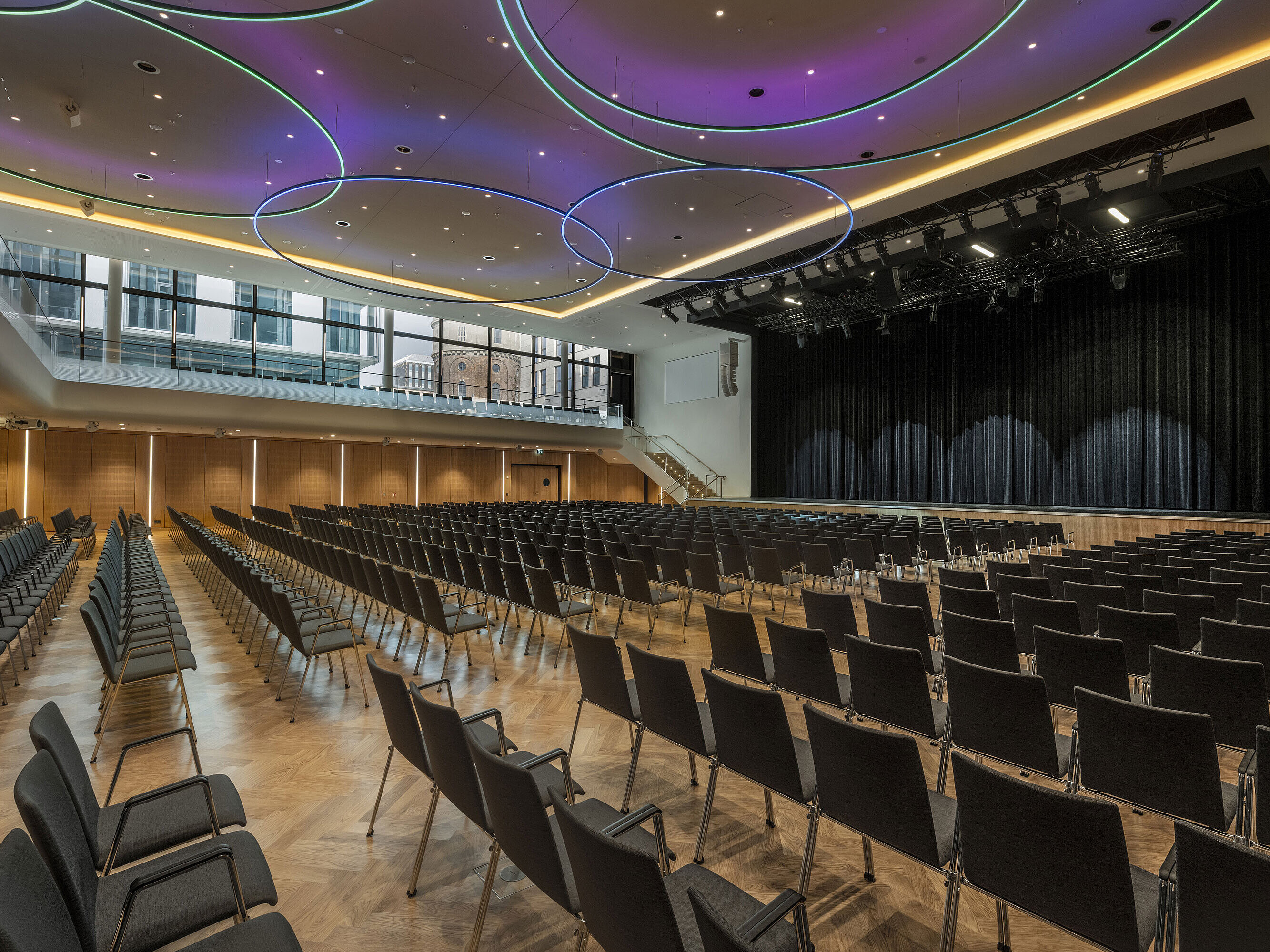 Modern event hall at Maritim Hotel Ingolstadt with stylish LED lighting and stage.