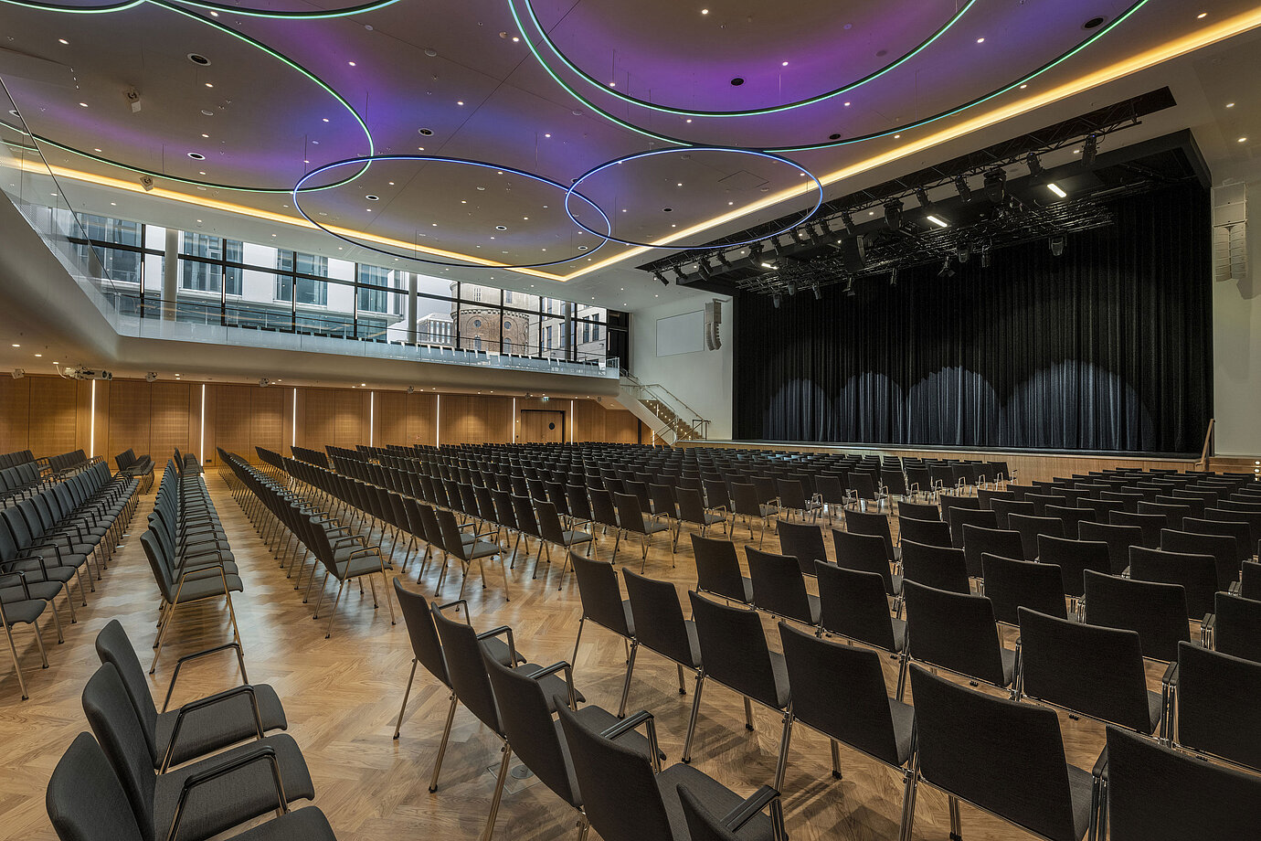 Modern event hall at Maritim Hotel Ingolstadt with stylish LED lighting and stage.