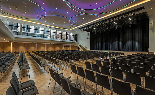 Modern event hall at Maritim Hotel Ingolstadt with stylish LED lighting and stage.