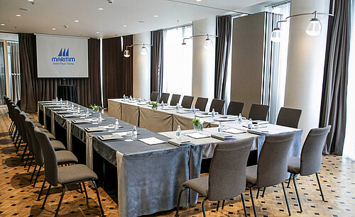 Modern conference room at Maritim Hotel Plaza Tirana with U-shape seating and natural daylight
