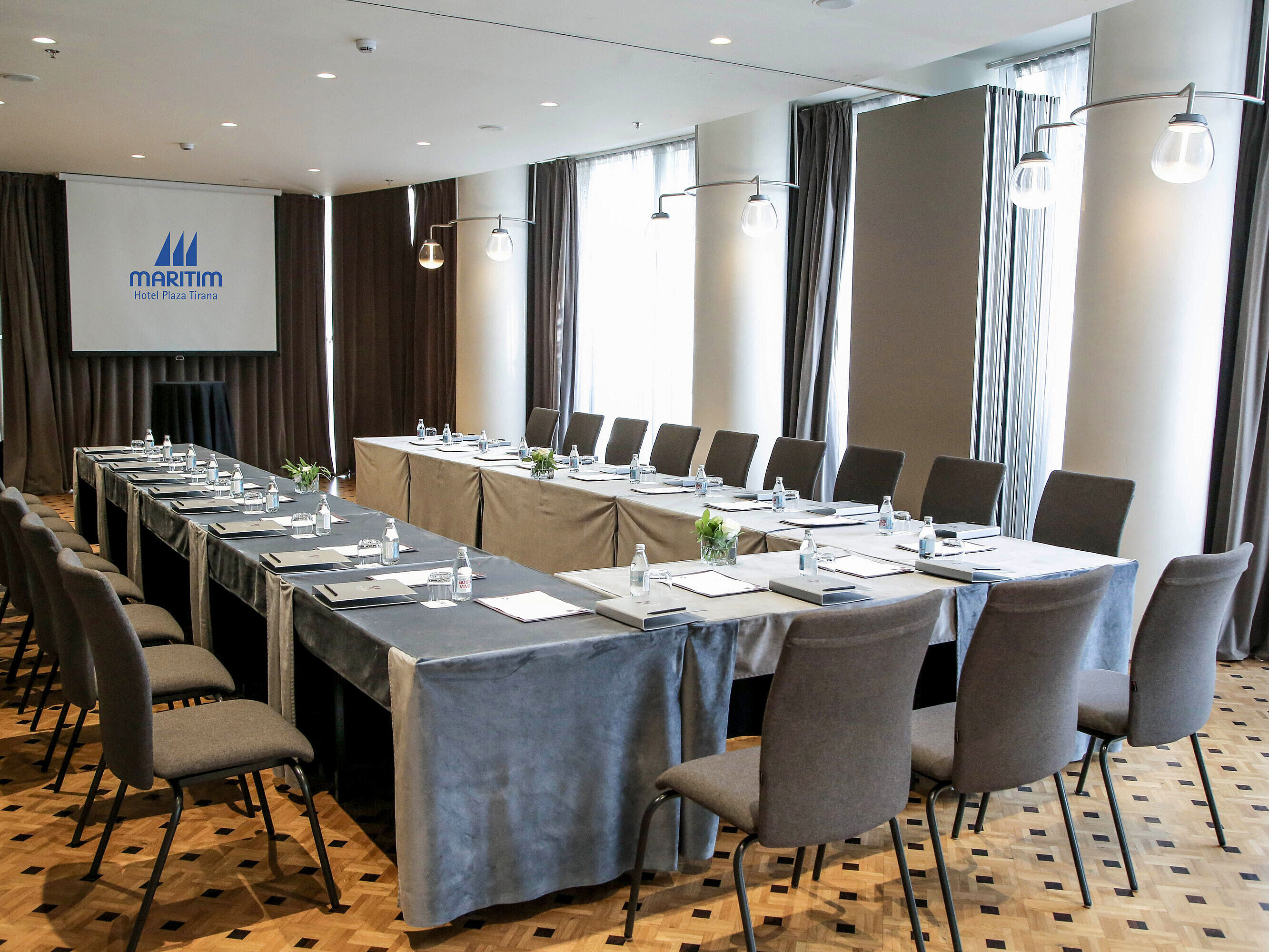Modern conference room at Maritim Hotel Plaza Tirana with U-shape seating and natural daylight