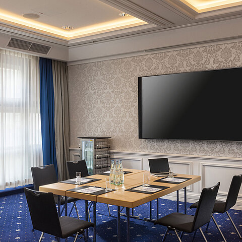 Conference room at the Maritim Hotel Würzburg with modern equipment and large screen.