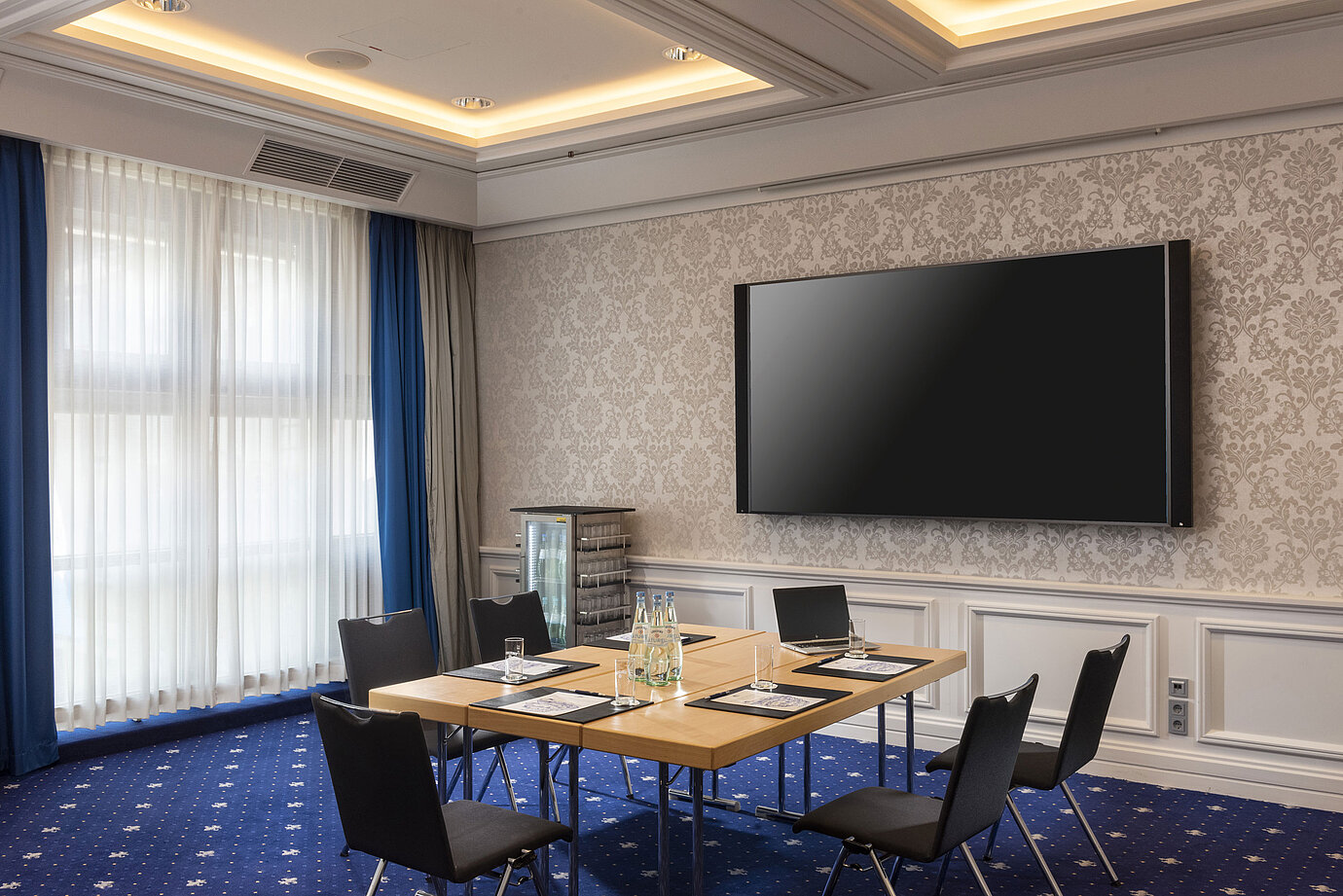 Conference room at the Maritim Hotel Würzburg with modern equipment and large screen.