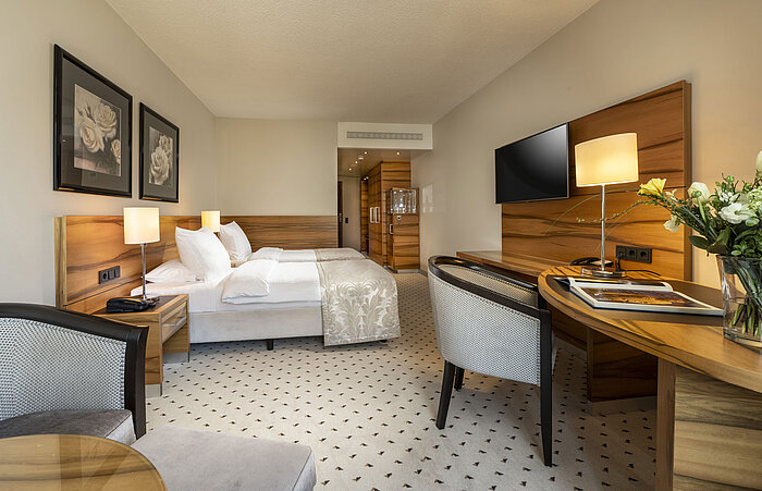 Comfort room at Maritim Hotel Bad Homburg with double bed, stylish wood decor and modern amenities.