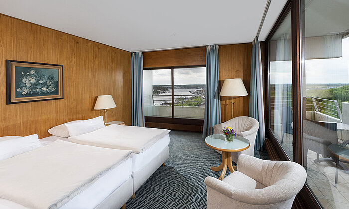 Double room with panoramic windows and view of Travemünde harbour at the Maritim Hotel