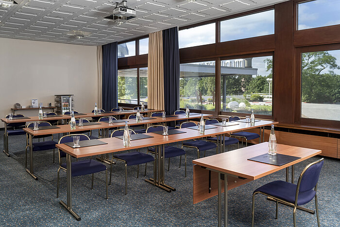Seminar room with row seating, carpet floor and large windows at Maritim Hotel Travemünde