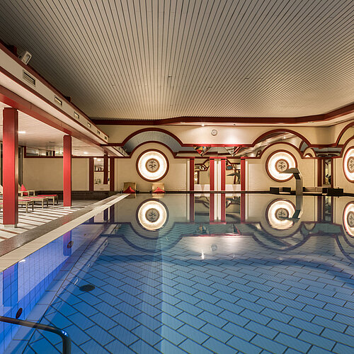 Spa area with loungers and large indoor pool at Maritim Hotel Bad Wildungen